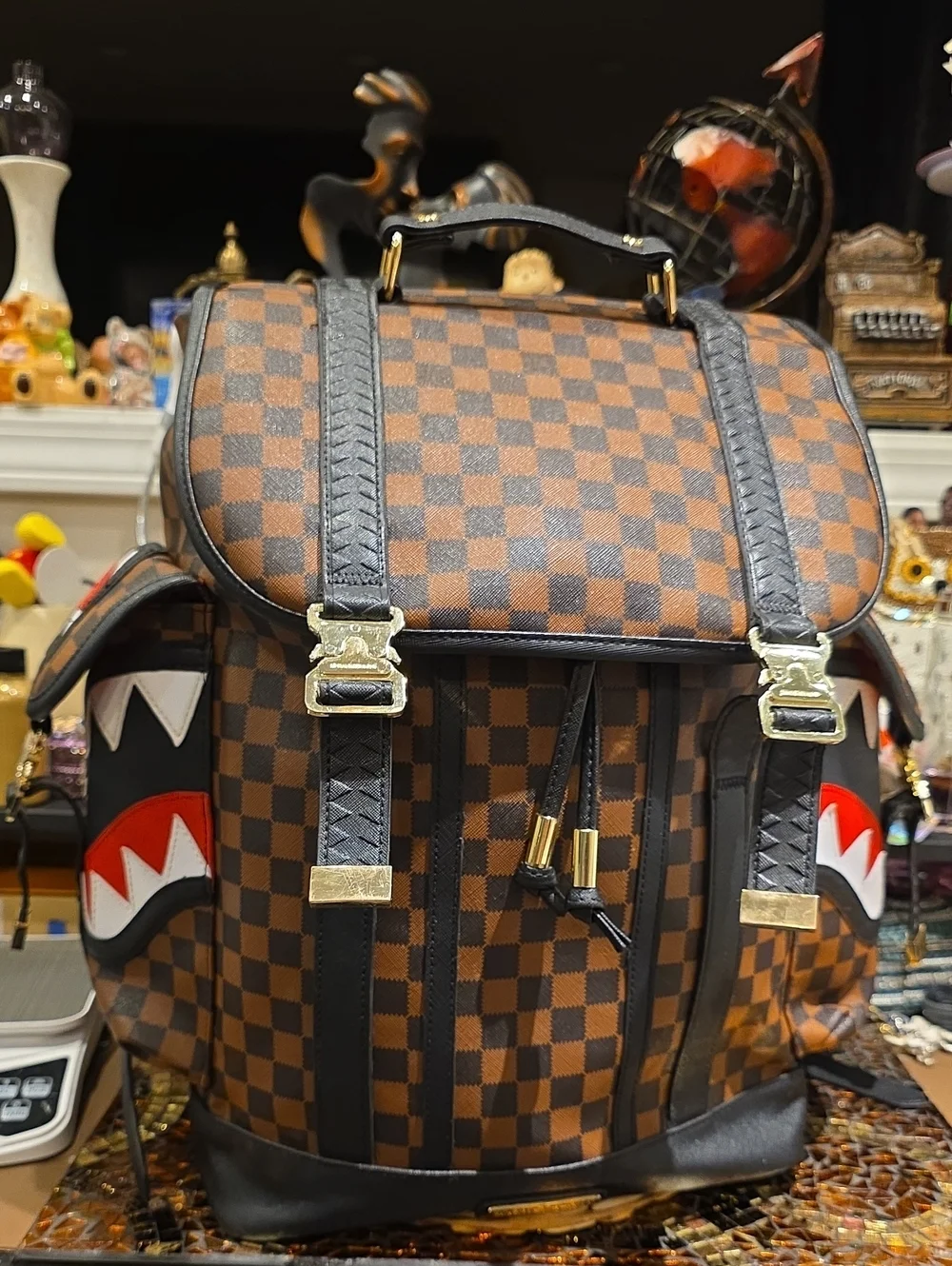 Sprayground Brown Checkerboard Backpack with Black Trim and Red Accent